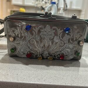 A beautiful crossbody with a lat space. Brand new.